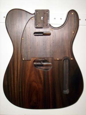 Solid santos rosewood with matching rosewood - maple laminated pick guard